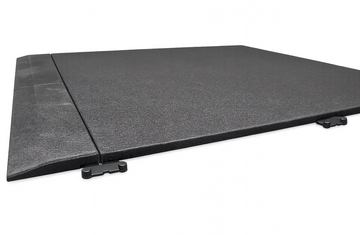 A 20mm black rubber gym tile with a matching edge ramp attached along one side