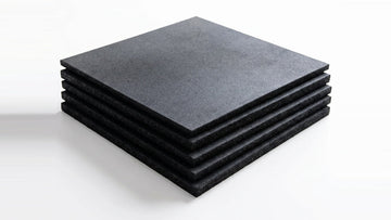 Stack of five black 1 m × 1 m rubber gym flooring tiles