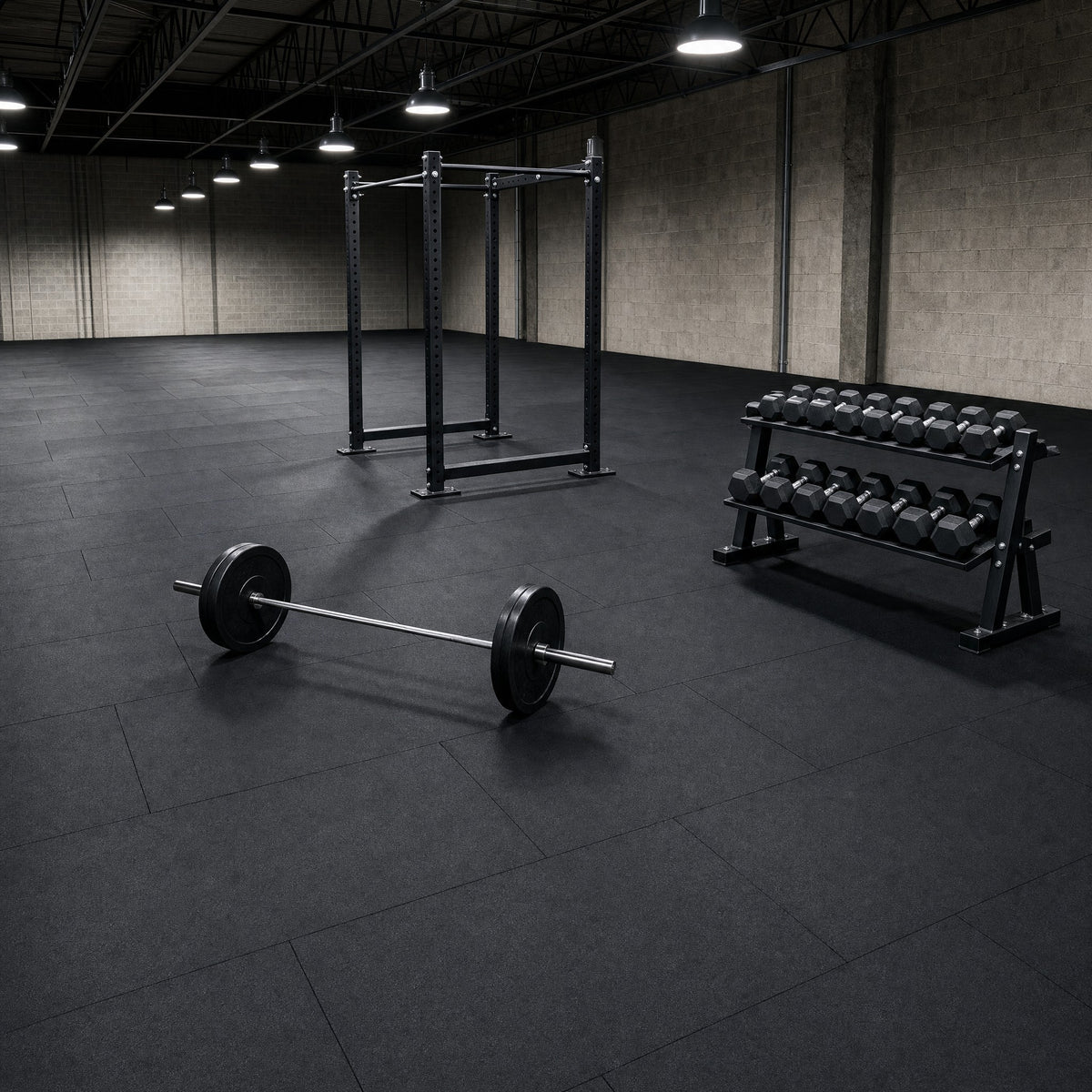 Heavy duty black 1m x 1m rubber gym flooring mats laid brick pattern in a commercial gym with a power rack, barbell and dumbbells